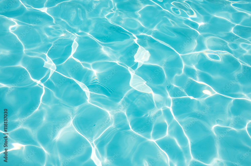 Blue Water surface with sun reflection in swimming pool