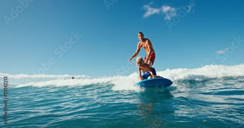 Father and son having fun surfing together, summer lifestyle family time