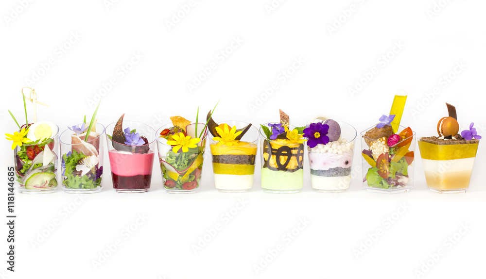 Fototapeta premium mini canapes in plastic cups decorated with edible flowers