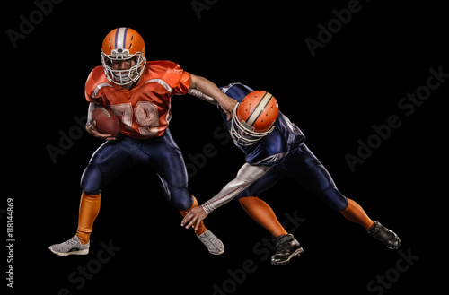 Two american football players passing play action on black background