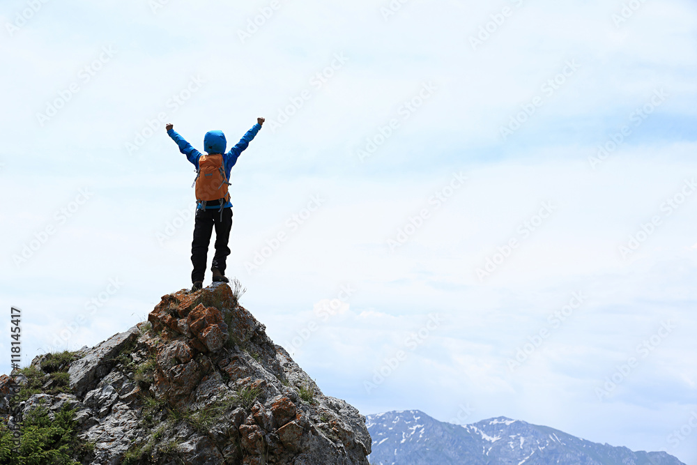 successful young woman backpacker open arms on mountain peak successful young woman backpacker open arms on mountain peak