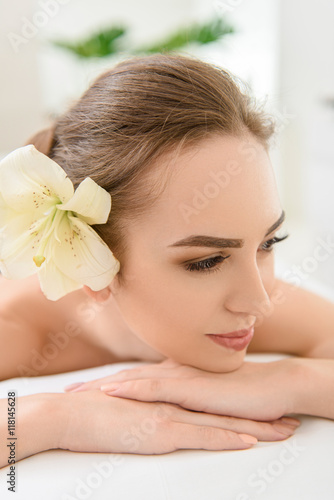 Happy young woman relaxing at spa center
