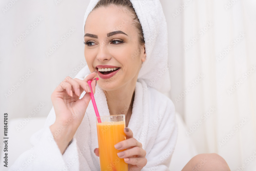 Joyful girl relaxing with healthy beverage at spa Joyful girl relaxing with healthy beverage at spa