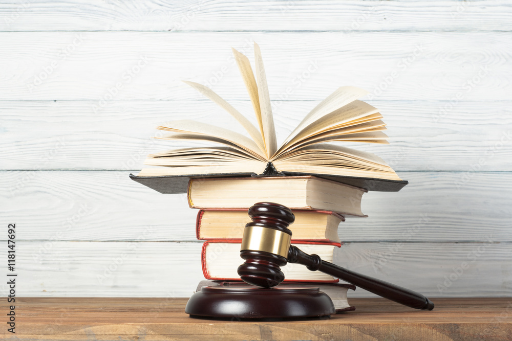 Law concept - Book with wooden judges gavel on table in a courtroom or enforcement office. Law concept - Book with wooden judges gavel on table in a courtroom or enforcement office.