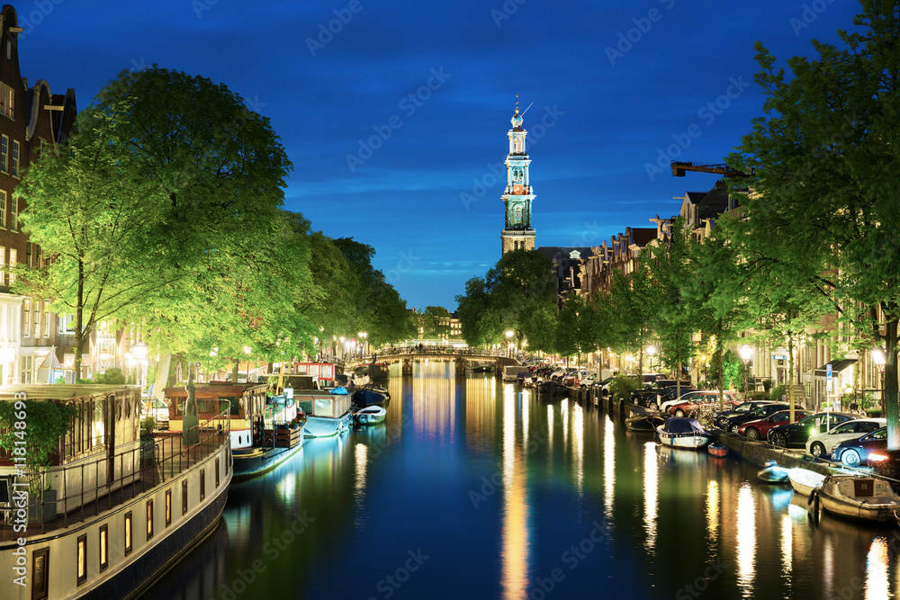 Westerkerk church tower at canal in  Amsterdam, Netherlands