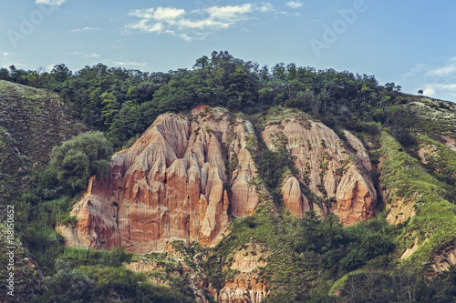 Scenic view of unique steep eroded sandstone cliffs of the Red Ravine (Romanian: Rapa Rosie), a geological reserve and a natural monument in Alba county, Romania.