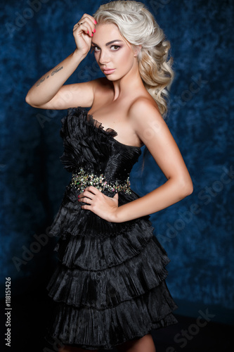 Fashion blonde woman in party black dress