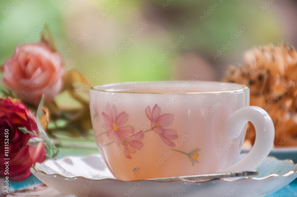 Hot tea with fried sweet pastry on wooden table Hot tea with fried sweet pastry on wooden table