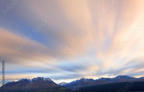 Long exposure of cloud movement above snow capped mountains.