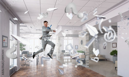 Jumping businessman in office . Mixed media © Sergey Nivens