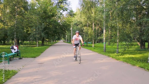 Wallpaper Mural A man rides a bicycle in the park on a sunny day. Torontodigital.ca