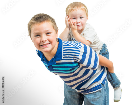 Loving Big Brother Carries Little Brother On His Back photo