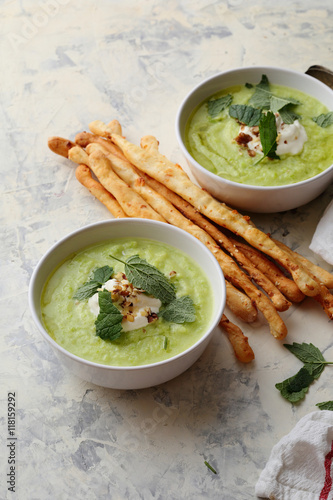 Bowls of broccoli and green peas cream soup