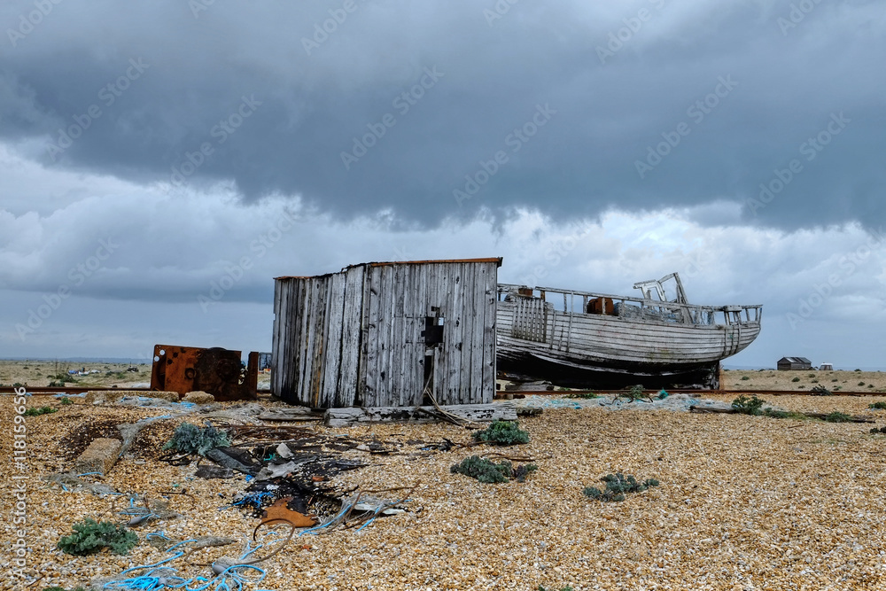 An overcast day,  Dungeness, kent, with abandoned buildings and boats.