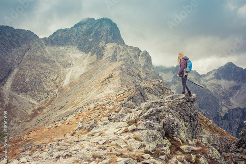 woman adventure hiker on mountain summit