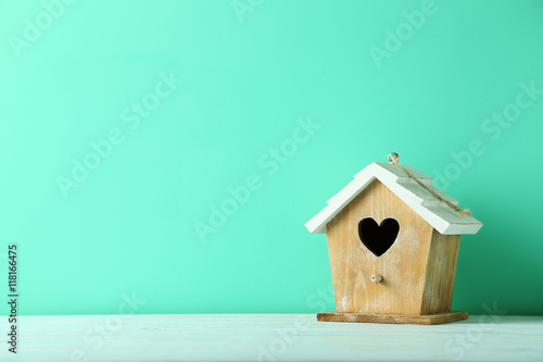 Fotobehang Nesting box on a green wooden table