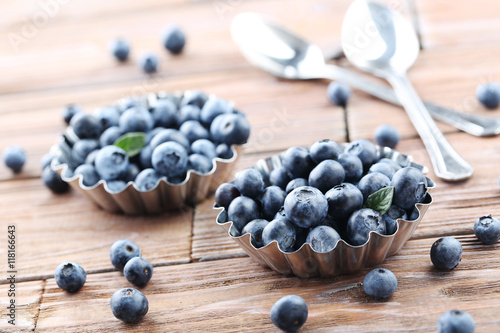 Ripe and tasty blueberries on brown wooden table