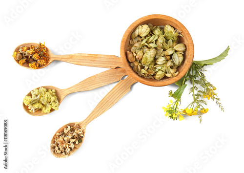 Natural flower and herb selection in wooden spoons isolated on white