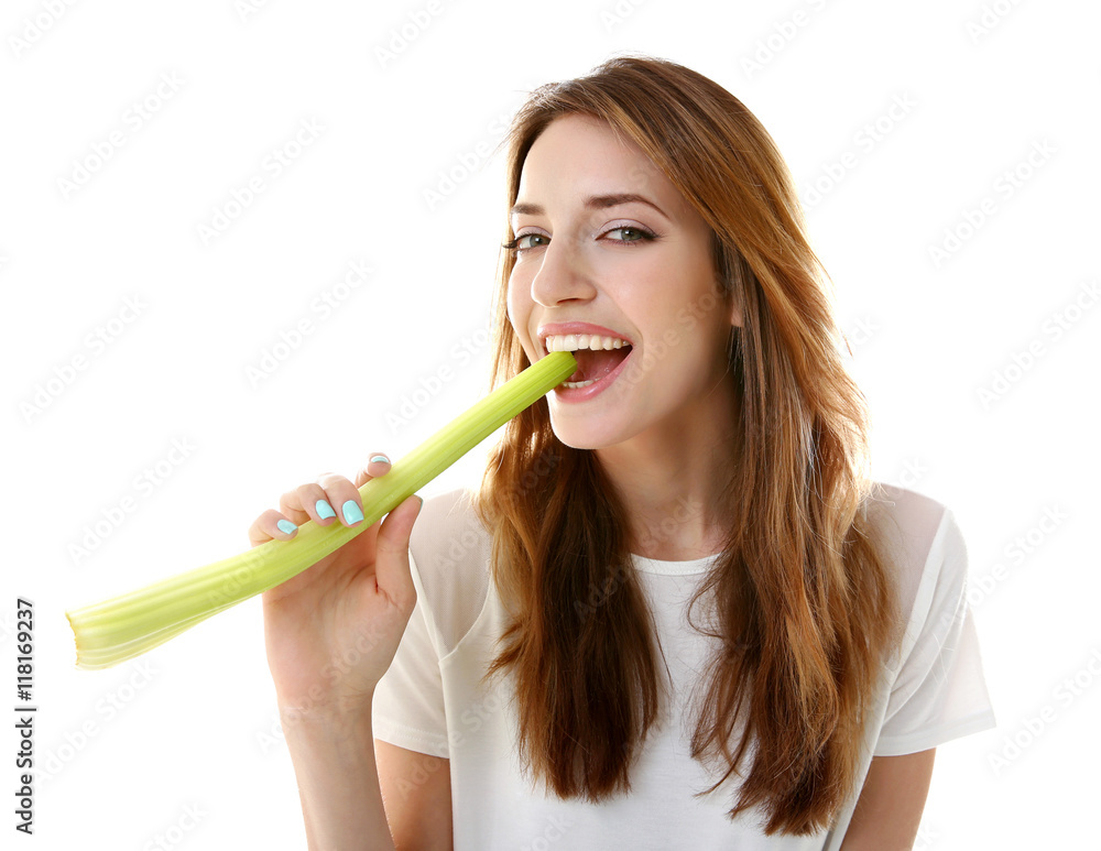 Beautiful girl eating celery, isolated on white