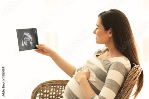 Young pregnant woman lookin...