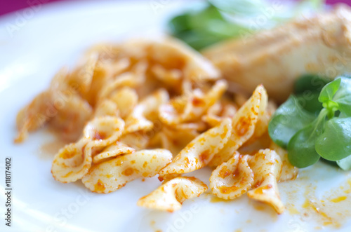 Italian pasta farfalle butterfly bow-tie with tomato basil sauce. Pasta dish.Cooked farfalle pasta on plate.