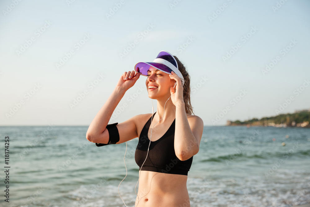 Runner girl wearing earphones and running armband ready for workout Runner girl wearing earphones and running armband ready for workout
