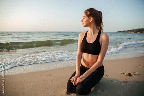 Portrait of a beautiful girl sitting outdoors at the beach