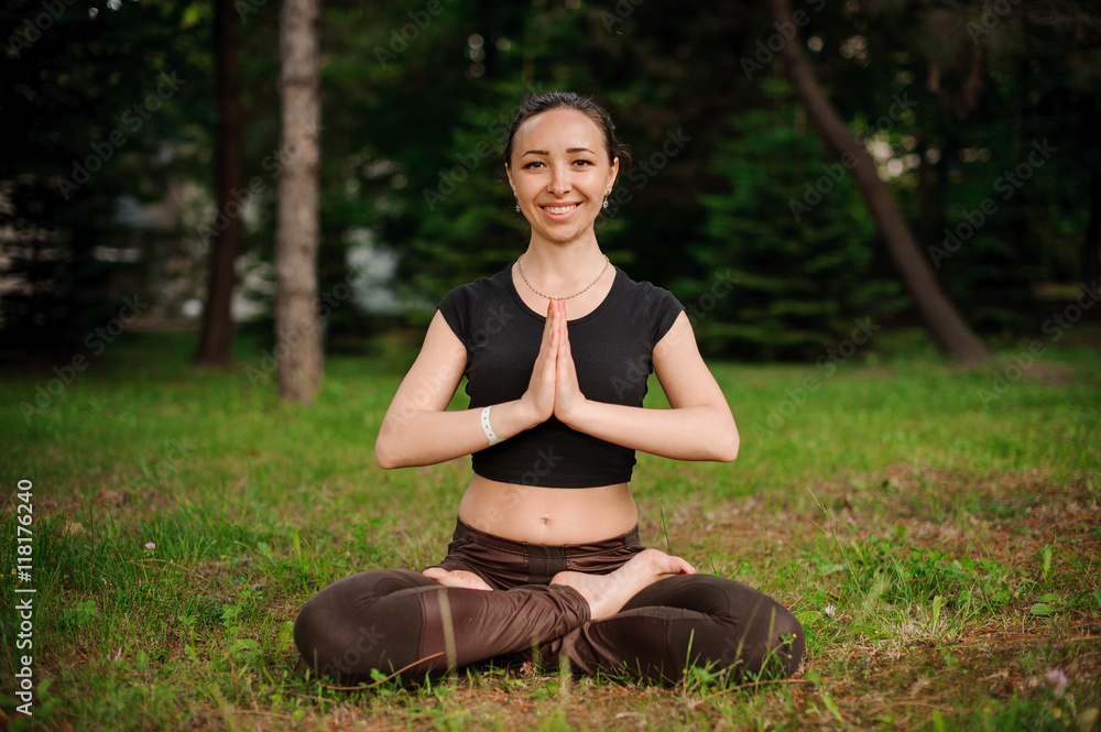 Nature yoga session in beautiful green woods, between trees. Meditation - namaste in lotus pose. Nature yoga session in beautiful green woods, between trees. Meditation - namaste in lotus pose.