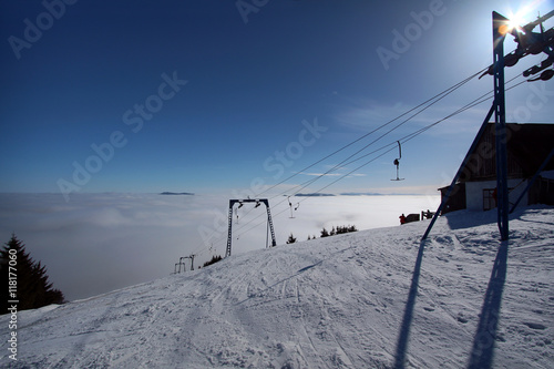 morning tranquil ski resort with clouds in a valley