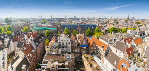 Panorama of residential areas. Aerial view. Amsterdam from above, apartment buildings, historic houses of the old city quarter, Holland, Netherlands.