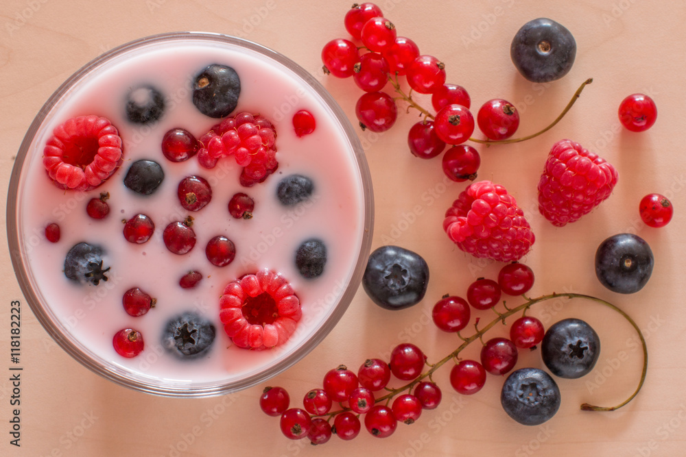 Yogurt with forest berries on wooden table Yogurt with forest berries on wooden table
