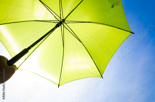 Green umbrella and blue sky