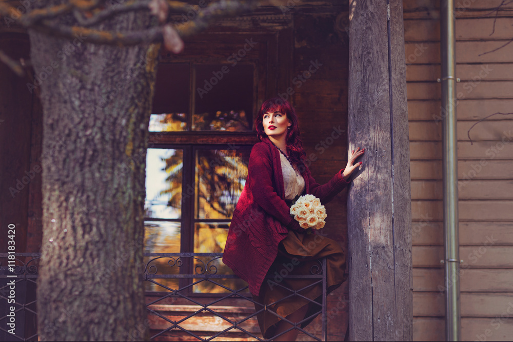 Obraz premium Girl sitting on old house balcony