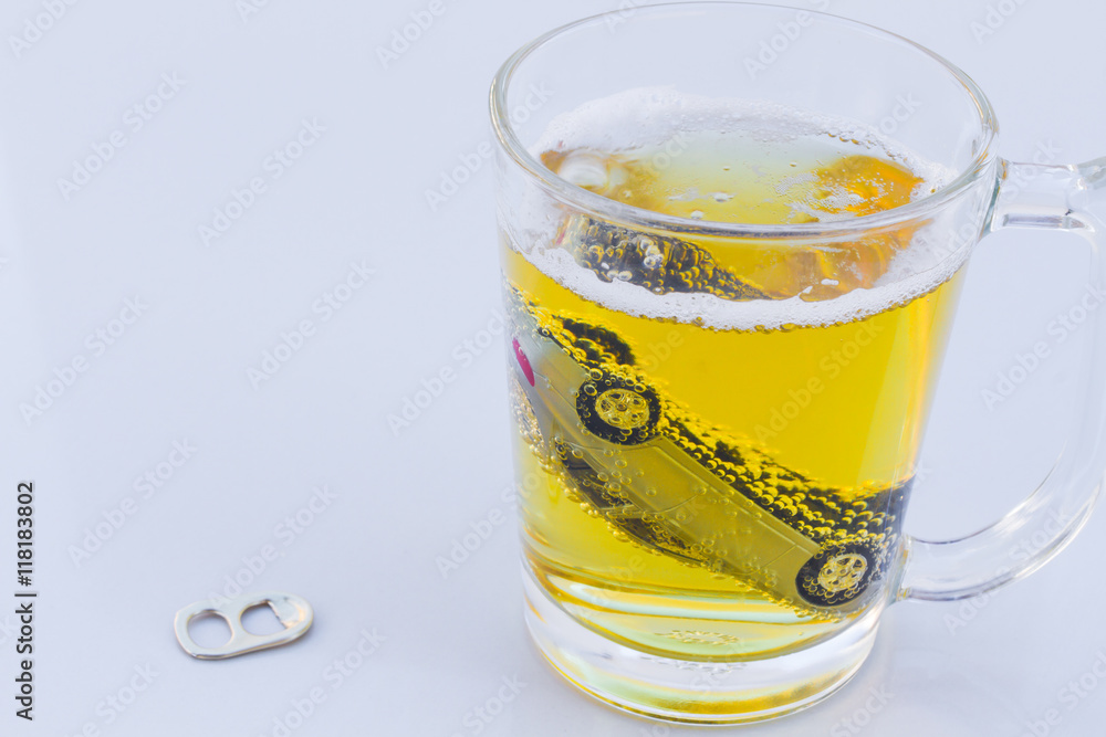 horizontal photo of toy car in a glass of beer isolated on white background horizontal photo of toy car in a glass of beer isolated on white background