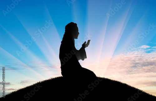 Muslim prays at sunset