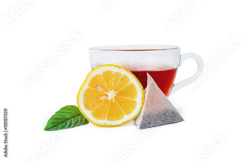 Glass cup of tea with lemon and leaf of mint isolated on white