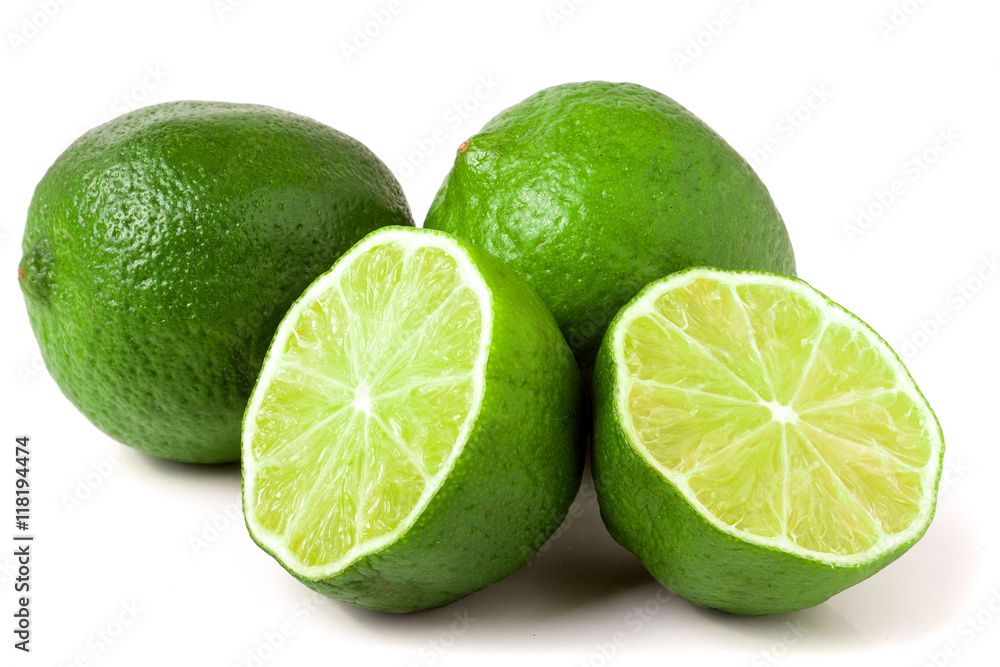 two limes with halves isolated on white background two limes with halves isolated on white background