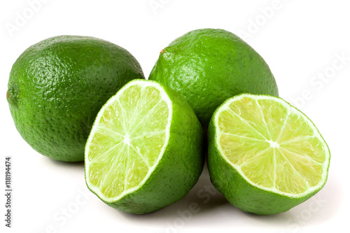 two limes with halves isolated on white background