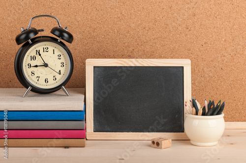 Back to school background with alarm clock, chalkboard and penci photo