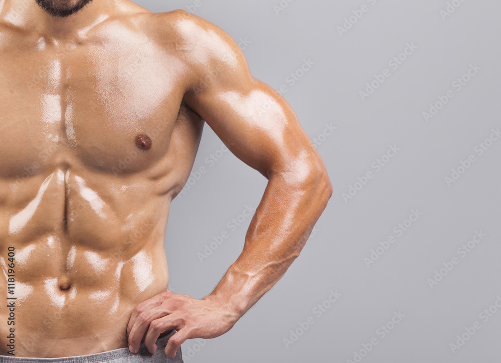 Fototapeta premium Bodybuilder torso on grey background