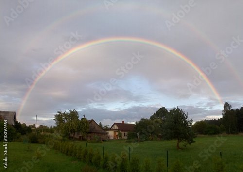 Rural landscape with real rainbow