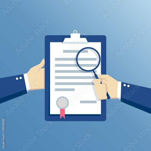 Business concept contract inspection, hands holding the contract and examine its conditions through a magnifying glass