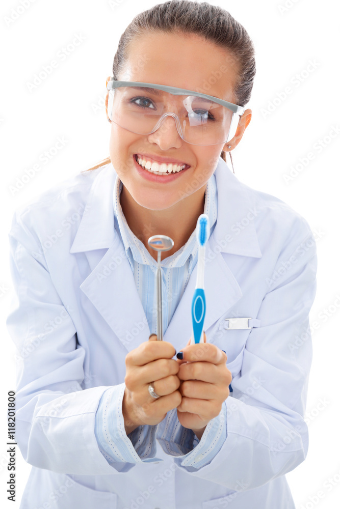 Beautiful female dentist doctor holding and showing a toothbrush isolated on a white background Beautiful female dentist doctor holding and showing a toothbrush isolated on a white background