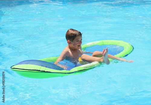 A young boy playing in a swimming pool while on vacation, 2016