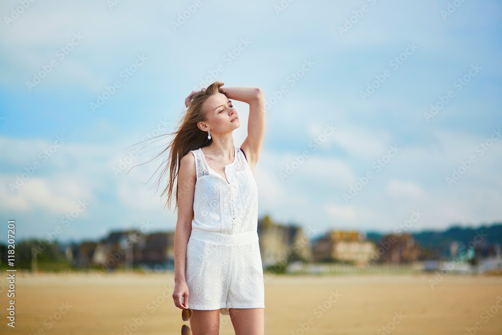 Beautiful young woman enjoying sun on a sand beach Beautiful young woman enjoying sun on a sand beach