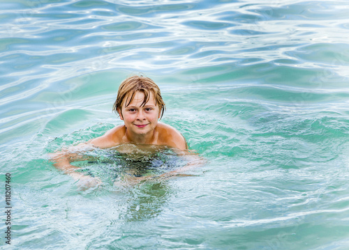 child is swimming in the ocean