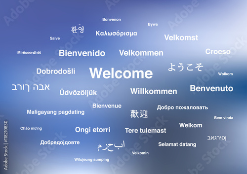 Welcome phrases in different languages of the world on blue blurred background