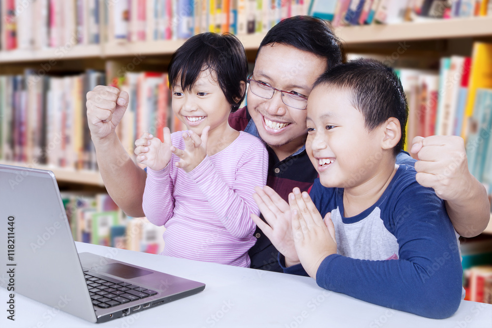 Kids clapping hands with teacher in library Kids clapping hands with teacher in library