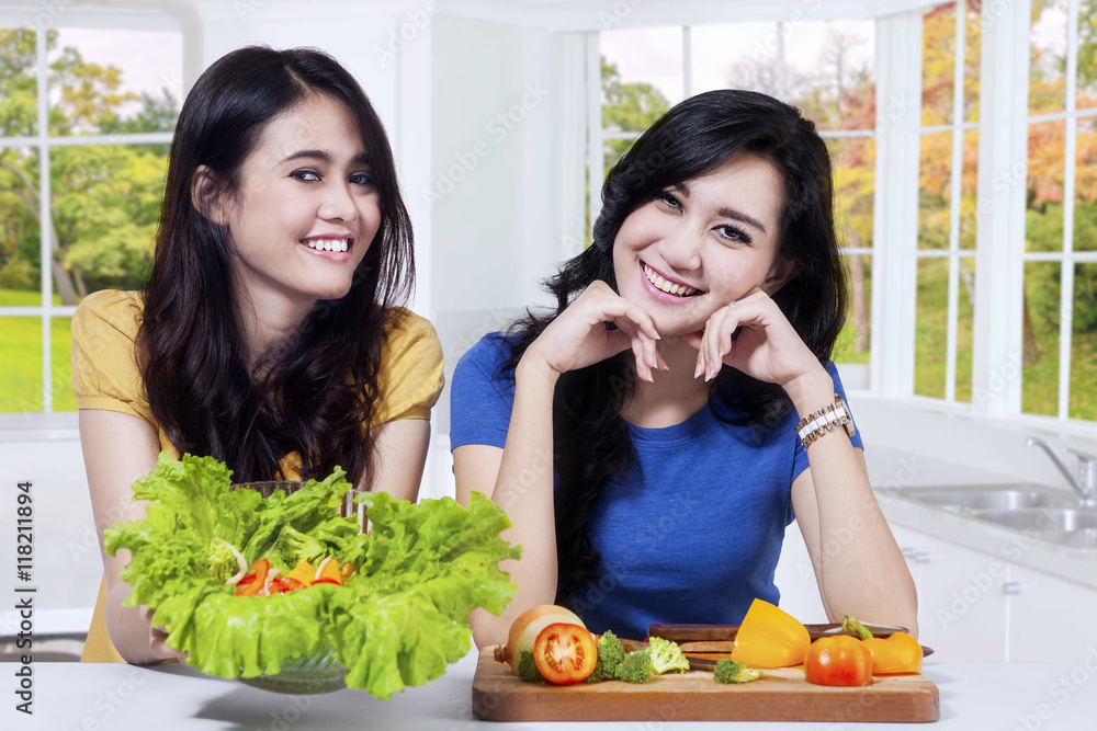 Two beautiful woman shows healthy food Two beautiful woman shows healthy food