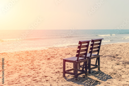 Empty Two Wood Chair on The Beach in Sunny day, Low Season Sea Travel No Tourist Concept. © Quality Stock Arts